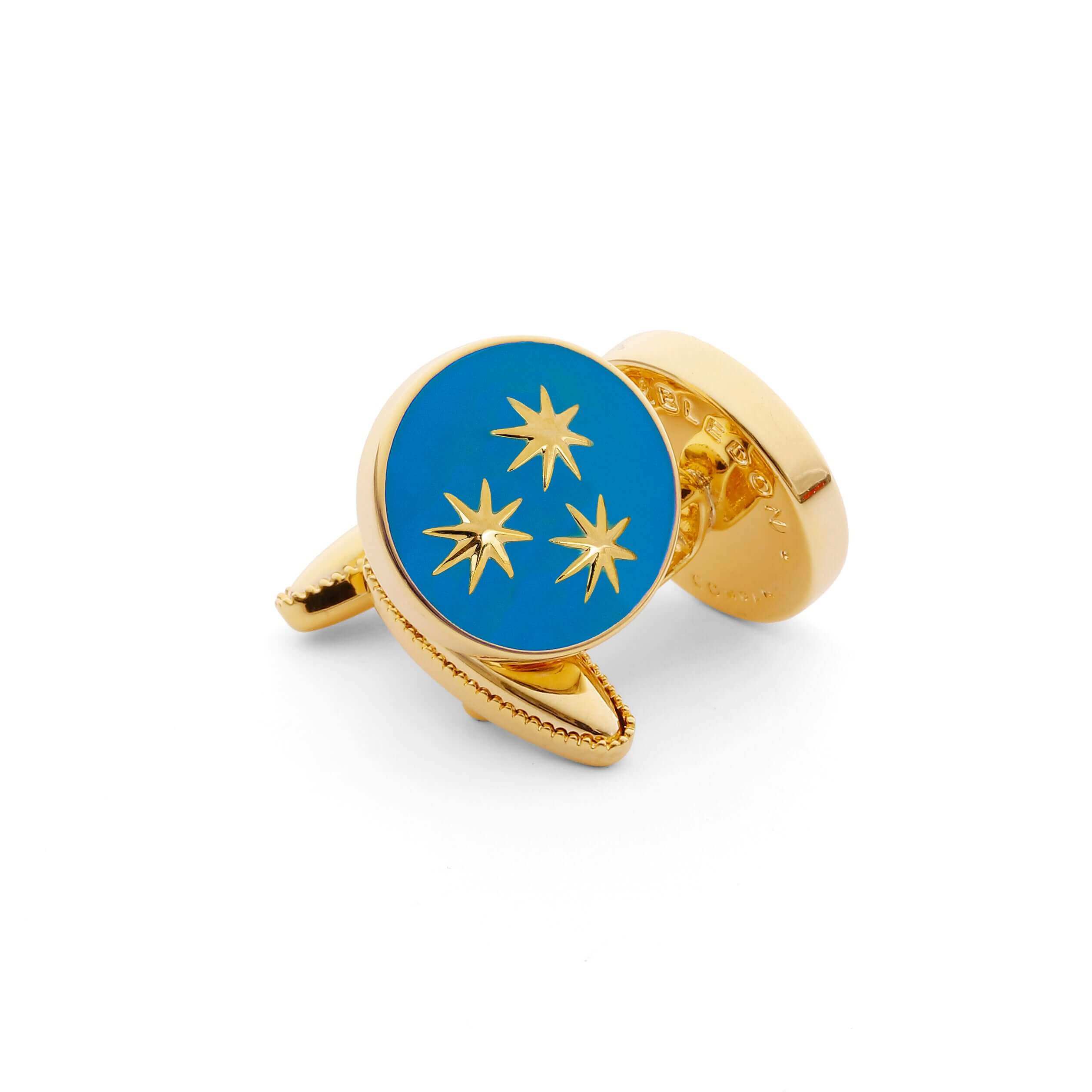 The St Philip Neri Cufflink - light blue enamel with golden stars in a gleaming gold base, supporting Brompton Oratory London