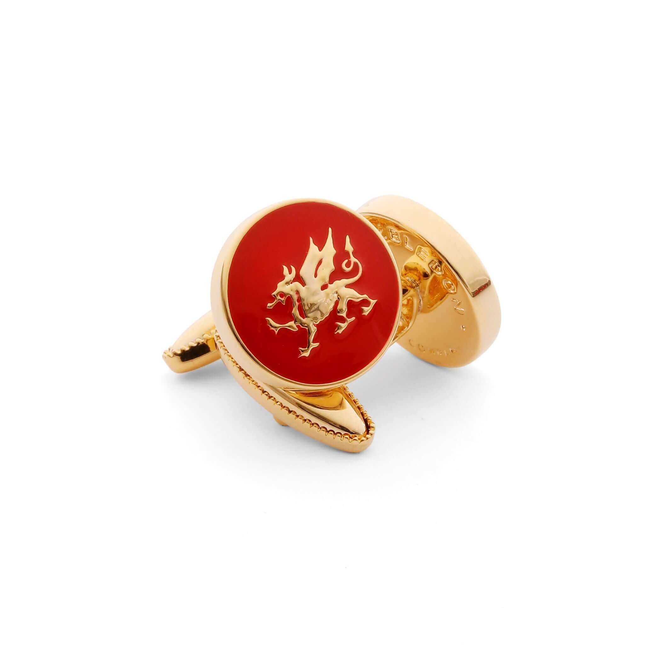 Gold Welsh Dragon cufflinks on red background symbolizing resilience and nationhood.