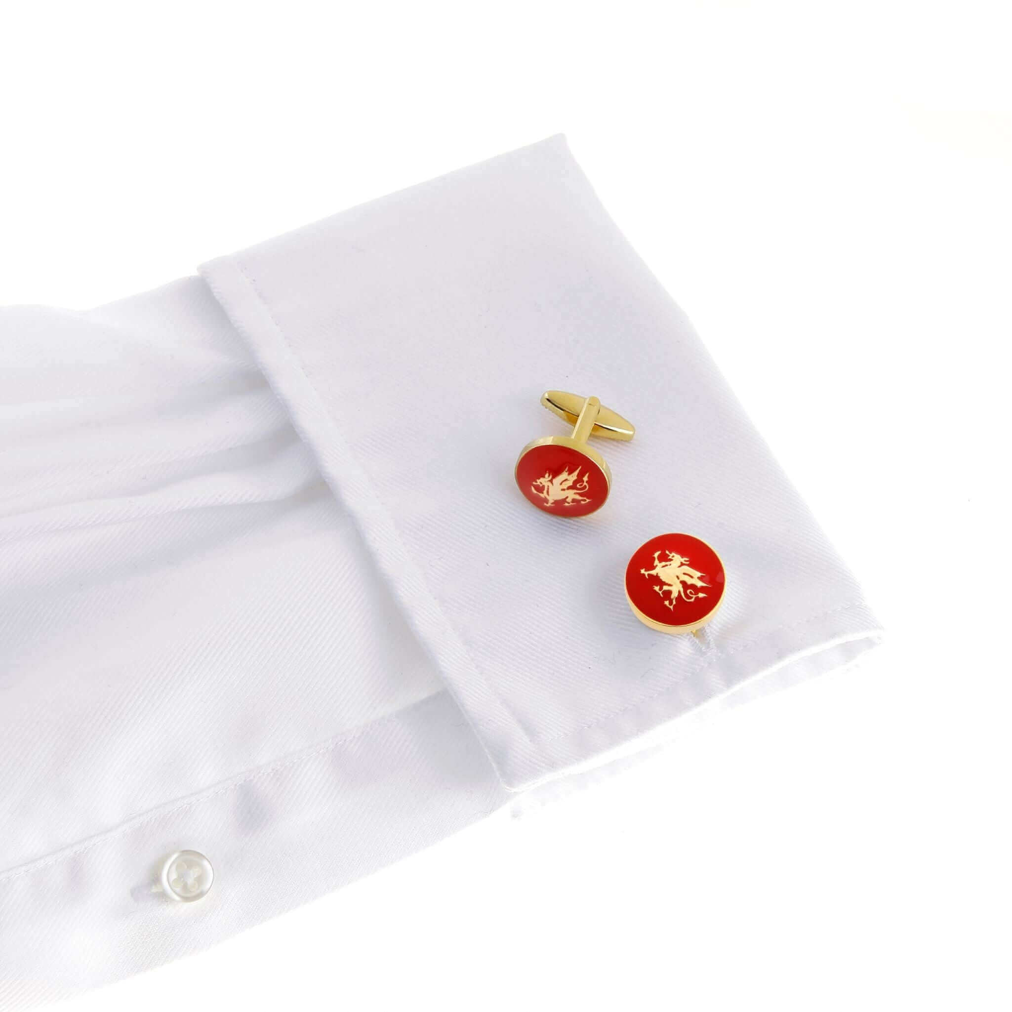 The Welsh Dragon Gold Cufflinks on white shirt sleeve with red background featuring the iconic dragon design.