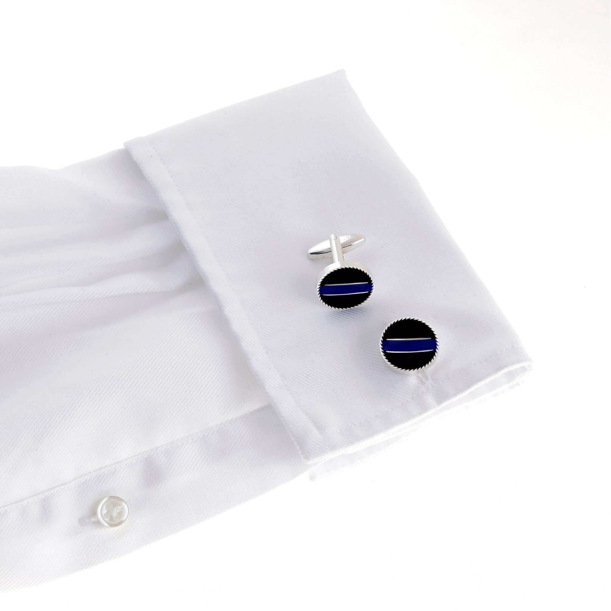Thin Blue Line police cufflinks on white dress shirt sleeve, honoring law enforcement officers.