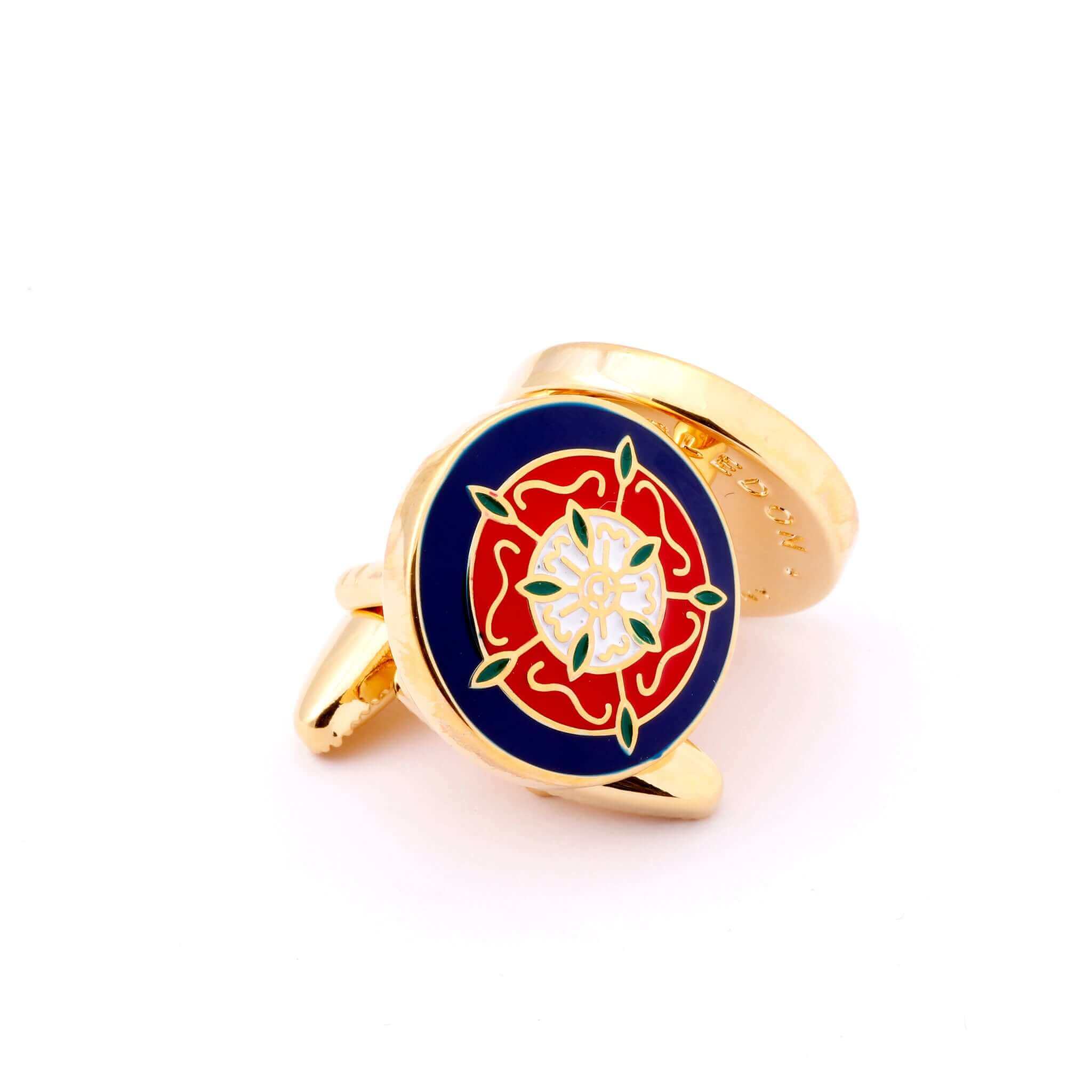 The Tudor Rose Gold Cufflink with red and white rose symbol on blue background representing unity and English heritage