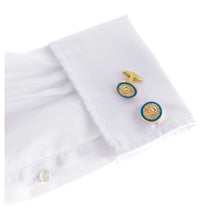 Gold lion cufflinks on white dress shirt symbolizing power, dignity, courage, and nobility.