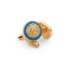 Golden Lion cufflink with detailed lion face, symbolizing power, dignity, courage, and nobility on a blue background.