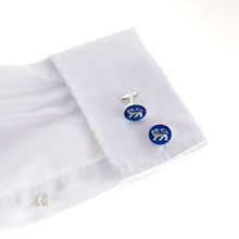 The English Leopard Gold Cufflink depicting a passant guardant lion on a white shirt cuff.